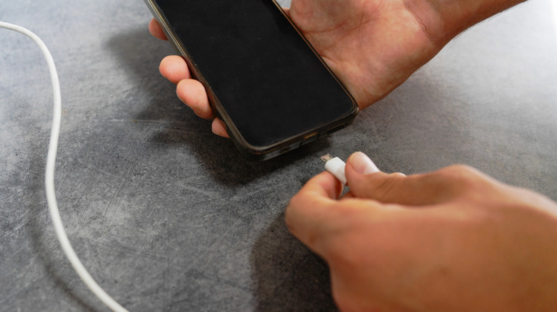 Why do phones still use battery when powered off?